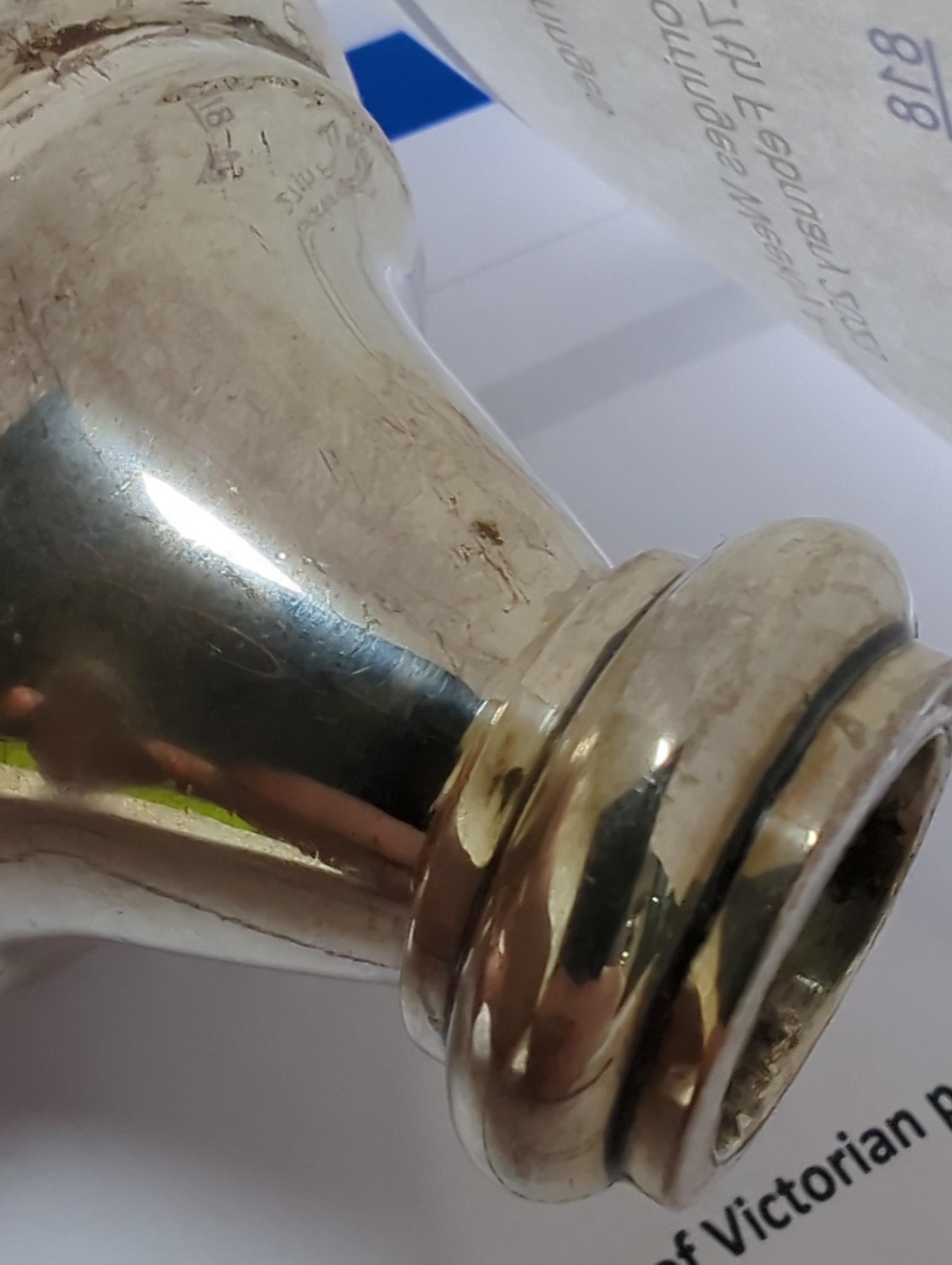 Thirteen assorted Iraq white metal and niello condiments, circular box, five similar napkin rings, a brooch and a pair of similar (damaged) candlesticks.